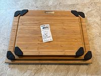 Three wooden cutting boards stacked, showing sizes and black corner grips