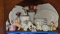 Overview of Lenox decorative plates, canister, dog figurines including one non-Lenox dog, vases, and small decorative gift box pieces.