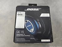 Front of original Bose QC15 headphone box showing blue headphones image, model name, and branding.