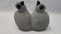 Front view of the two quail birds sculpture showing texture and color detail.