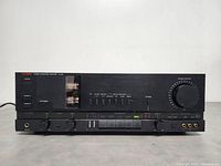 Front view of amplifier showing full front panel layout with volume knob and input switches