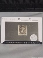 Full overview photo of the 6 cent brown Canadian stamp Scott #27 on a black and white background card with writing.