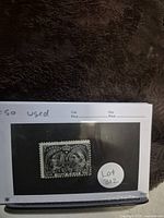 Photo of the used 1897 Canadian 1/2 cent black Jubilee Issue stamp mounted on black background paper with a white label 'Lot 312'