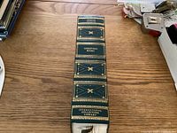 Book spine vertically oriented on a wooden table, showing title and publisher clearly.