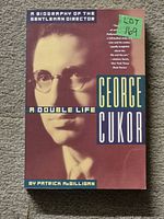 Front cover of the book showing the title, author, and a portrait of George Cukor with a sticker identifying lot number 169.