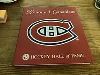 Front cover of the hardcover book 'Honoured Canadiens' by Hockey Hall of Fame featuring the Montreal Canadiens logo.
