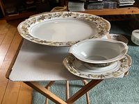 Top view of serving platter and gravy boat with attached underplate on wooden stand