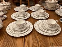 Main view of six complete place settings showing cups, saucers, bread plates, salad plates, and dinner plates