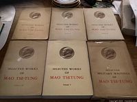 Six hardcover books laid out, showing front covers with embossed profile of Mao Tsetung and titles in black and red text.