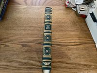 Image of the spine of the hardcover book "Sense and Sensibility" by Jane Austen, published by International Collectors Library, showing gold embossing on green binding.