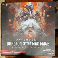 Top view of the Waterdeep Dungeon of the Mad Mage board game box with cover art showing fantasy characters