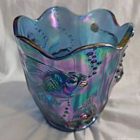 Close-up view of the vase showing iridescent blue-purple finish and embossed koi fish design.