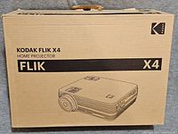 Image of the Kodak Flik X4 Home Projector original cardboard box showing the product name and a sketch of the projector.