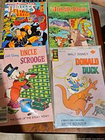 Photo showing Teenage Mutant Ninja Turtles, The Jungle Book, Uncle Scrooge, and Donald Duck comic books