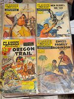 Four Classics Illustrated comic books: Ten Great Years by Miles Standish, Men Against The Sea, Oregon Trail, Swiss Family Robinson.
