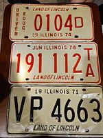 Nine vintage Illinois license plates stacked in three vertical groups showing various years and conditions.