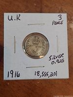 Front side of the silver 3 pence coin dated 1916 with '3' numeral crowned and surrounded by laurel leaves.