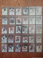 29 NHL All-Star vintage hockey cards laid out on a wooden surface in a grid, showing player images and team logos.