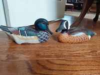 Side view of both carved ducks showing colors and details.