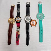 Five watches arranged horizontally showing different character designs and band types including leather and plastic; all watches untested needing batteries/replacement bands