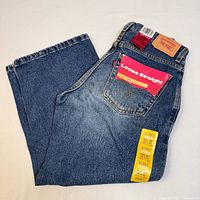 Levi's boys denim jeans showing back pockets, Levi's tag, and attached original tags including size and fit details.