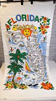 Full view of the vintage Florida beach towel showing detailed map and colorful tropical illustrations.