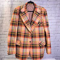 Front view of bold plaid vintage men's sport jacket showing button closure and flap pockets.