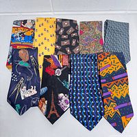 Top view showing all 9 vintage men's ties with various patterns and colors arranged side by side on a white background.