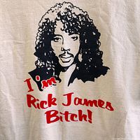 Close-up of the Rick James graphic and red lettering on the T-shirt showing details of print and fabric texture