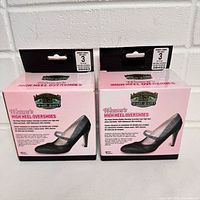 Two unopened boxes of Moneysworth & Best Women's High Heel Rubber Overshoes size 3, front view showing product image and branding.