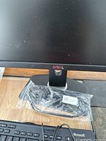 Close-up of one Dell 24-inch monitor showing Dell logo on the front bezel. Power and HDMI cables are sealed in plastic.