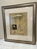 Full view of the framed artwork showing the botanical print of freesia flower and ornate frame.