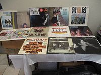 Overview of all 13 vinyl LP records displayed on table showing album covers from The Beatles, Paul McCartney, The Beach Boys, George Harrison, and others.