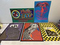 Five posters laid flat showing full lot