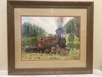 Full view of framed watercolor painting of steam locomotive on tracks with forest background