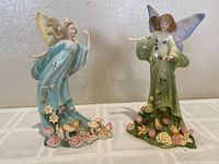 Two fairy resin figurines side by side showing colors and size