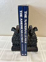 Bookends holding two thick hardcover books titled 'The American League' and 'The National League'.