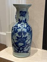 Full-frontal view of vase on floor showing overall shape and motif