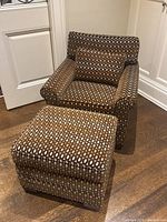 Chair and ottoman set shown at slight angle, seating and footrest visible