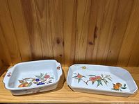 Pair of Royal Worcester Evesham serving dishes on wooden shelf, one square with handles, the other longer and rectangular, showing fruit decoration and gold trim