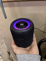 Top view showing iQ branding and glowing LED ring in purple/blue