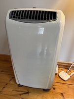 Front view of portable air conditioner showing white housing and top air vent