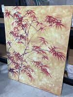 Full view of large decorative art on canvas showing autumn leaves branch with warm tones and textured beige background