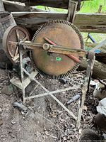 Front view of rusted concrete mixer on tripod frame