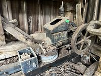 Close view of engine block, fuel tank opening, governor linkage and small tool box on skid rail