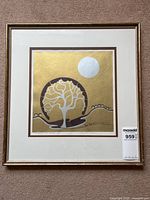 Full view of the framed serigraph 'Sheep to the Shade' with metallic gold background, tree, moon and sheep figures