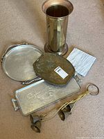 Overview showing all items in the lot including the trays, marble board, bells, and umbrella holder.