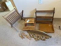 Overview of all wooden decorative items and shelves in the lot including magazine holder, shelves, tray, gecko figurines, and ornate resin shelf