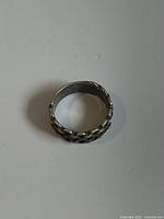 Top angle showing the complete chain-link pattern around the silver band ring.