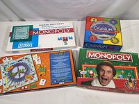 Lot of four board games: two Monopoly versions, Cranium, and The Sixties.